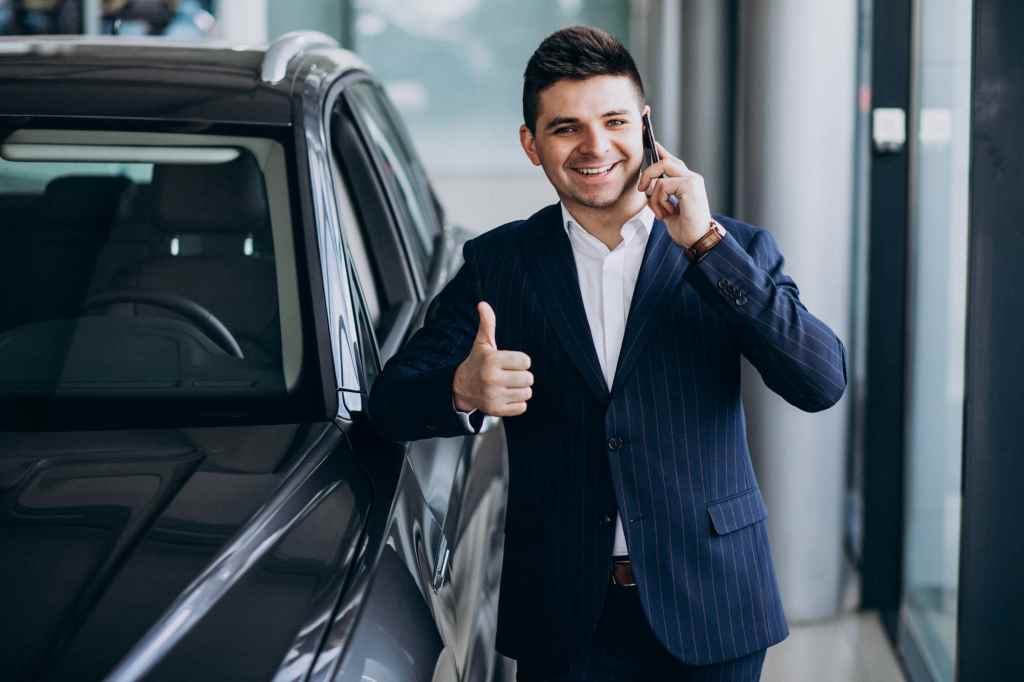 business man in a car showroom choosing a car